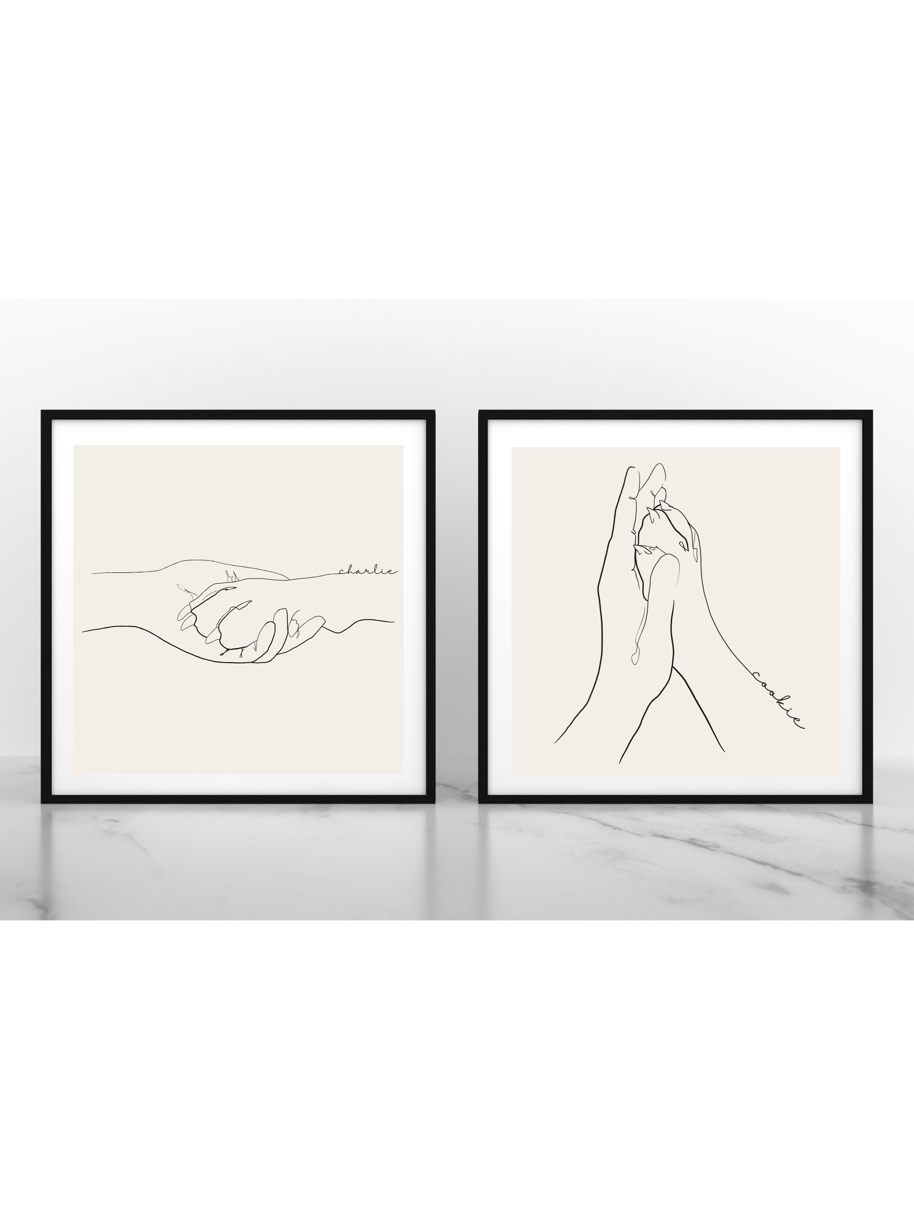 Zwei minimalistische Line-Art-Poster in schwarzen Rahmen. Auf der linken Seite befindet sich das Poster 'Pfötchen', das eine Hand zeigt, die eine Pfote hält. Auf der rechten Seite das Poster 'Patita', das ebenfalls eine Hand darstellt, die eine kleine Pfote umfasst.