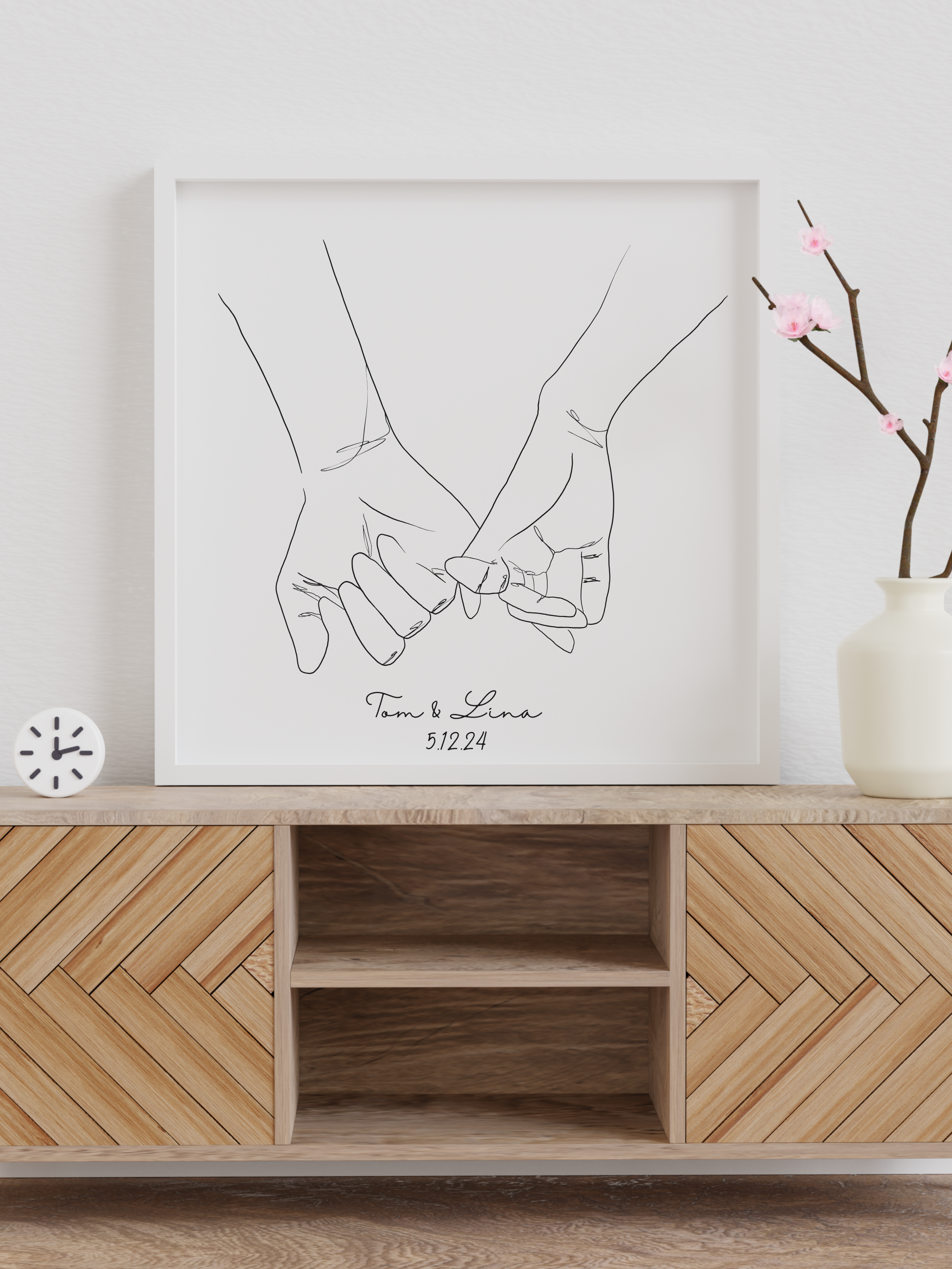 Das Line Art Poster "Pinky Promise" von Sels Studio wird eingerahmt auf einem Sideboard dargestellt.
